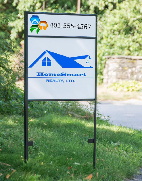 Real estate sign for HomeSmart Realty, Ltd. with a phone number 401-555-4567, placed on a grassy lawn near a stone wall and trees.