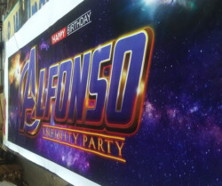 A birthday banner with a galaxy theme reads "Happy Birthday Alfonso Infinity Party" in bold letters, resembling a popular superhero franchise logo.