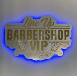 Sign reading "Line Up BARBERSHOP VIP" in gold lettering on a white background, outlined with a blue glow.