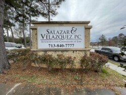 A stone sign at 1405 reads "Salazar & Velazquez, P.C. Attorneys and Counselors at Law" with the phone number 713-840-7777. The sign is surrounded by trees and parked cars.